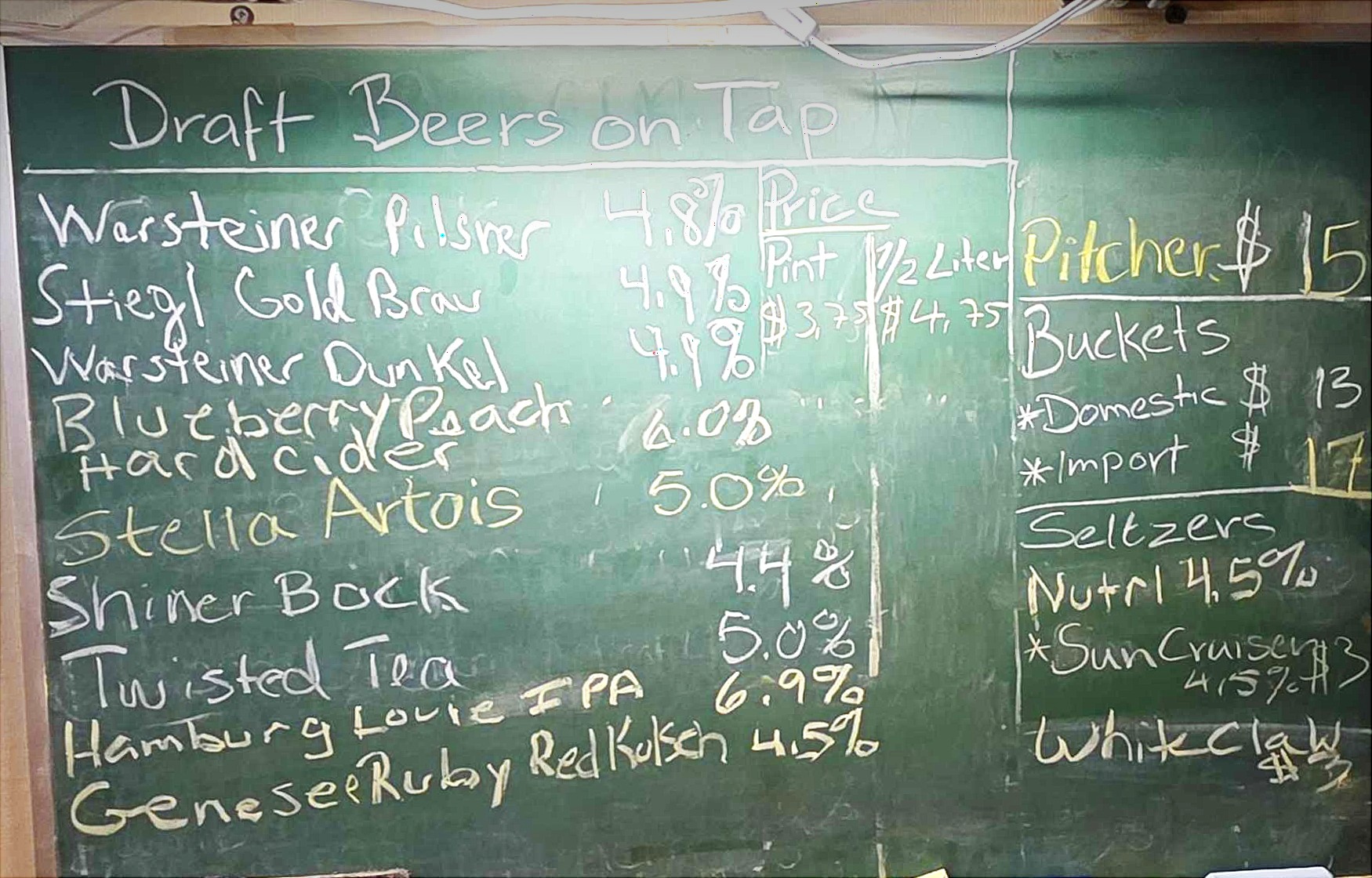 Draft beers on tap chalkboard at Cleveland Maennerchor — featuring Warsteiner Pilsner, Stiegl Gold Brau, Warsteiner Dunkel, Hard Cider, Stella Artois, Shiner Bock, and more